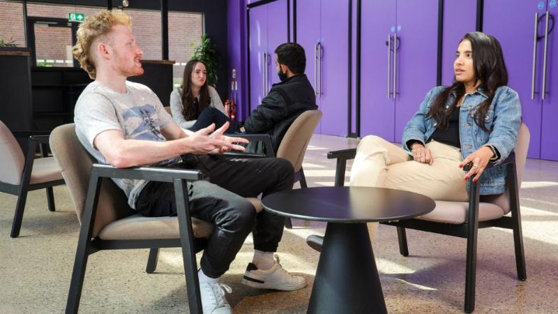 two students sitting chatting